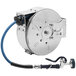 A silver and blue T&S hose attached to a stainless steel hose reel.