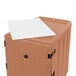 A brown plastic container with a white sheet on top.