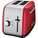 A red and silver KitchenAid 2 slice toaster.