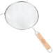 A Tablecraft medium tin double mesh strainer with a wooden handle.