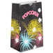 A black Bagcraft Packaging popcorn bag with colorful fireworks on it.