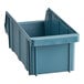A close-up of a blue plastic container with an open lid.