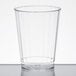 A clear Fineline disposable plastic tumbler on a white surface.