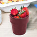 A Tablecraft maroon speckle condiment bowl filled with strawberries on a table.