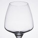 A clear wine glass with a stem.