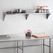 A Regency stainless steel wall shelf above a kitchen counter.