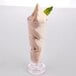 A GET SAN plastic dessert shot glass filled with chocolate ice cream with mint leaves.