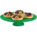 A green Tablecraft cast aluminum round platter with fruit on it.