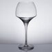 A clear wine glass with a stem.