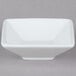 A Tuxton porcelain white mini footed square bowl.