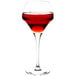 A Chef & Sommelier round wine glass filled with red liquid.