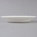 A close up of a white Arcoroc rim soup bowl.