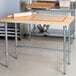 A rolling pin on an Eagle Group wood top work table.