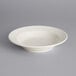 A Tuxton Reno eggshell china soup bowl on a gray surface.