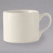 A white Tuxton China steakhouse cup with a black handle.