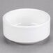 A Tuxton white stackable china bowl on a gray surface.
