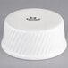 A white Tuxton china souffle/ramekin with a swirl design on the sides.