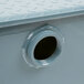 A close-up of a hole in a metal pipe.