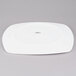 A Tuxton white square china plate with a small hole in the middle.