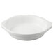 A white Tuxton round au gratin dish with a handle.