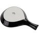 A black and white Tuxton China fry pan server paddle.