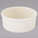 A white Tuxton China ramekin with a ribbed design.