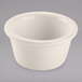 A Tuxton eggshell white china ramekin with a rim on a white background.