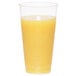 A WNA Comet Classicware clear plastic fluted tumbler filled with orange juice with a white background.