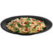 A Tablecraft black cast aluminum platter with pasta, shrimp, and vegetables.