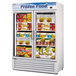 A Turbo Air glass door merchandising freezer filled with frozen food.