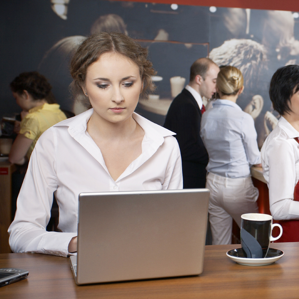 woman working on a computer in a restaurant