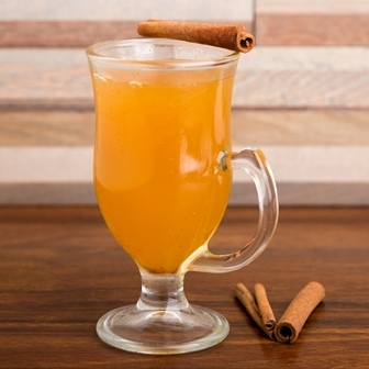 Glass of apple cider with cinnamon