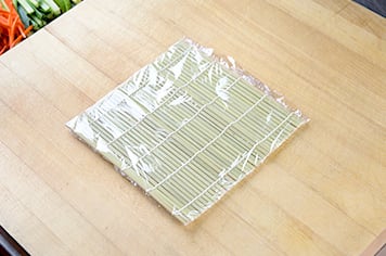 using plastic wrap to roll uramaki
