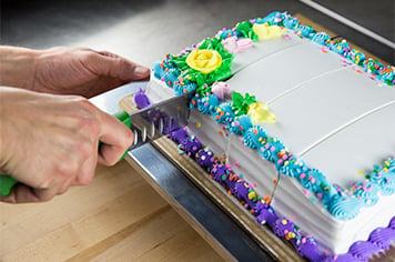 cutting a sheet cake