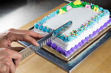 slicing a sheet cake