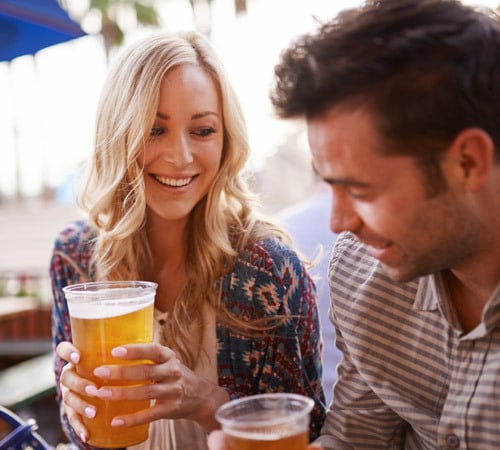 Couple enjoying drinks on Restaurant's Outdoor Patio