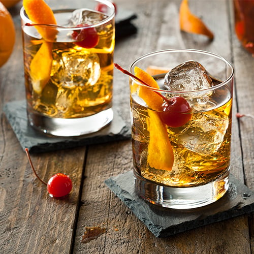 Old Fashioned cocktail with cherries and bitters