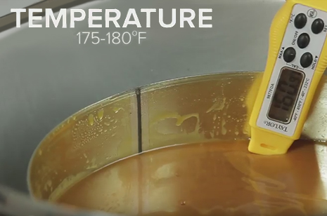 thermometer in melted caramel for caramel apples