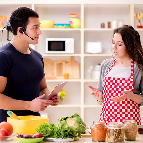 Female chef talking to male set assistant for cooking video