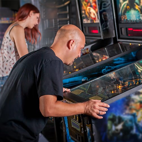 Customers playing arcade bar games