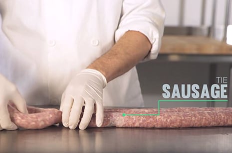 a chef creating sausage links