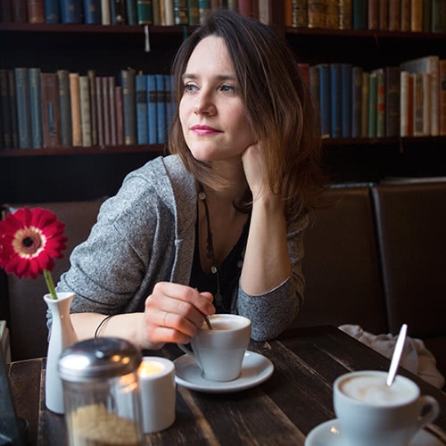 woman enjoying coffee at a bookstore cafe