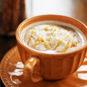 Pumpkin Spice Latte with whipped cream and caramel drizzle