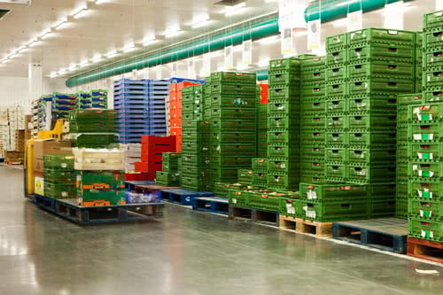 shipping warehouse with shipping crates and forklift