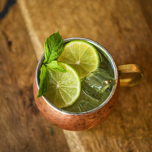 Top view of a moscow mule cocktail in a copper mug