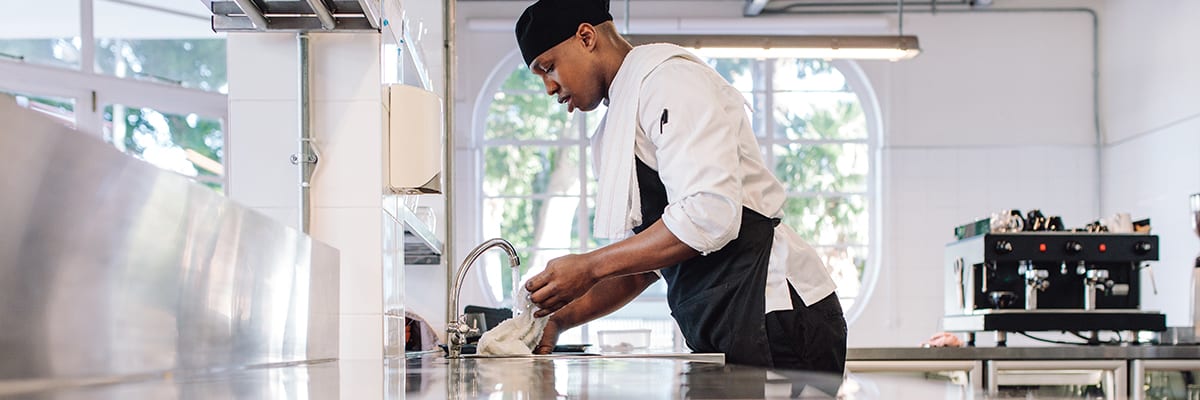 chef washing rag in the sink