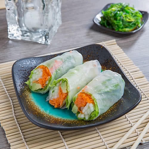 spring rolls on brown and turquoise stoneware square plate