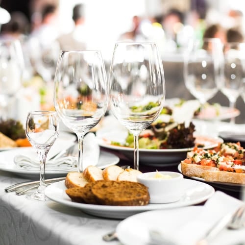 classy table setting for 5 course meal with wine glasses and hors d'oeuvres