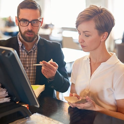 restaurant owners looking at a computer