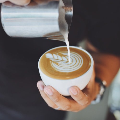 Making latte art at a coffee shop